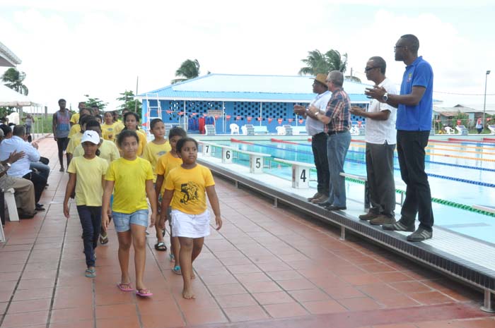 Director of Sport Christopher Jones (right), Dr. Joseph Haynes, Cuban Ambassador Julio Caesar and GASA’s Ivan Persaud taking the March Past during the opening ceremony.