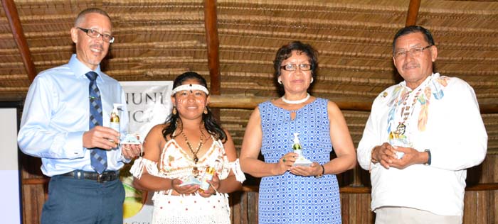 Minister of Business, Dominic Gaskin; a young woman, who is featured in the advertising campaign of the Luxury Facial Cleanser; and Indigenous Peoples’ Affairs Ministers Valerie Garrido-Lowe and Sydney Allicock, pose with bottles of the cleaner and soap.