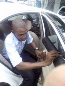 Setting the example: A policeman  complying with the recently handed down directive and immediately removes the tint from his vehicle