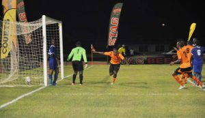 Clive Nobrega (center) scores the equalising goal for Slingerz against Pele. Franklin Wilson photo