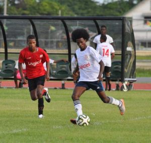 Jaheem Small (left) controls the ball as he goes after Friendship goal.