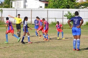 The Referee (2nd left) points to the middle following Mahaica Determinators 4th goal and first of two from Gary Jardine (4th right) in the 18th minute. (Franklin Wilson photo)