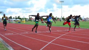 USA’s Phil DeRosier (right) out-leans his rivals to win the Digicel 4G Men’s 100m race at the National Track and Field Centre yesterday.