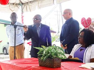 Sickle Cell patient Eaton London speaking as Minister Karen Cummings, PAHO/WHO rep. Dr. Edwards and NBTS Dir. Dr. Pedro Lewis look on.