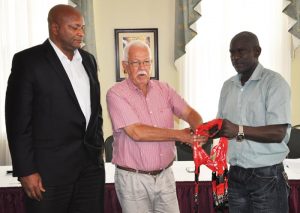 Veteran Broadcaster, Joseph ‘Reds’ Perreira (centre) hands over the whistles to GBOC Official, Dexter Douglas while GABF President, Nigel Hinds share the moment.