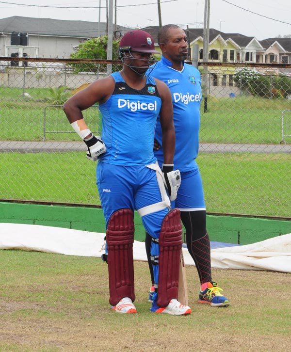 Head Coach Phil Simmons speaks with Johnson Charles during yesterday’s net session. 