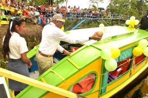 His Excellency, President David Granger officially commissioning the 'David Granger' as the residents and students of Moraikobai look on.