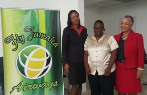 Lovern Williams (centre) is flanked by two Fly Jamaica representatives.