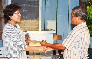Minister within the Ministry of Indigenous Peoples’ Affairs, Valerie Garrido-Lowe handing over the $2M cheque to Toshao of Kamwatta Hill, Ronald Manano 