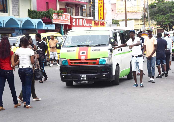 A tout trying to load this route 40 minibus yesterday afternoon.