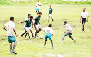 Beavers (green tops) and Wales United battling despite the conditions.