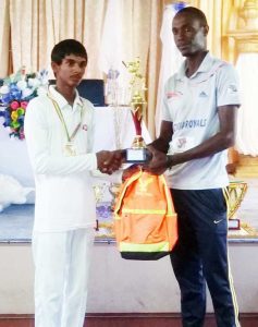 Chanderpaul Govindan receives his award as Cricketer of the Year from Coach Eon Hooper.