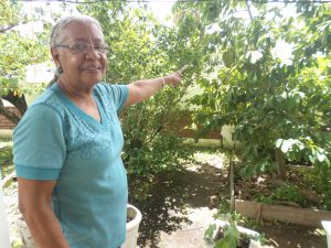 Showing off some of her fruit trees