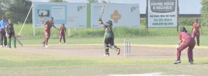 Guyana's Latoya Smith attempts a big hit against Leewards' Skipper Shawnisha Hector at Everest yesterday in her unbeaten innings.
