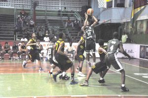 Jordan Alphonso towers above his defence for a jumper in the paint last night at the Cliff Anderson Sports Hall. 