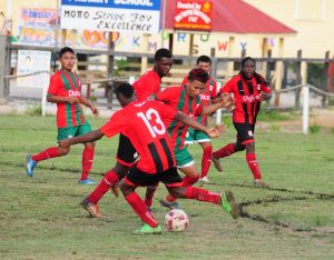 Uriah King (center) battles for possession. 