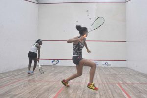 Taylor Fernandes clobbers the ball into the wall against Makeda Harding at the GT Club on Thursday night. (Sean Devers photo)