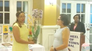 Immediate Past President Cherri Peters-Grant (left) hands over a token of gratitude to First Lady Sandra Granger.