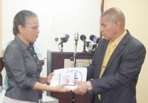 Minister of Health Dr. George Norton, receives the Final Report of the External Assessment from Ms Paula Trotter.