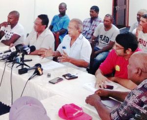  President of GAWU (gesturing) along with members of the union and representatives of the workers in the background during the briefing yesterday.