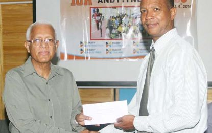 Massy hands over cheque for annual 10k race