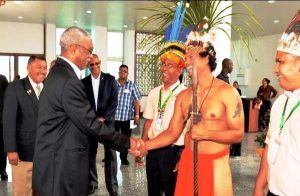 President Granger greets a participant of the National Toshaos Council Conference, as its Chairman, Joel Fredericks (third from right) and Minister of Indigenous People’s Affairs, Sydney Allicock (left of the President) look on. (Ministry of the Presidency Photo)