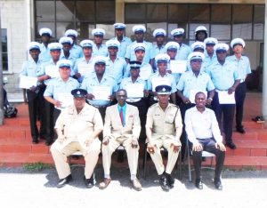  (From Left Sitting) Police Inspector Glenn Campbell; Heavy Equipment Operator Instructor, Tottil Saygon; Traffic Chief, Dion Moore; and Technical Officer of BIT, Richard Maughn during a photo op as the graduating ranks exhibit their certificates.