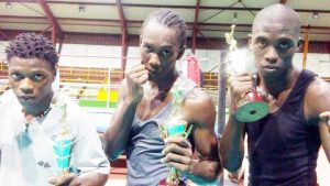 Three of the successful boxers of the REP boxing gym show off their hardware after the  tournament ended. From left: Joshua Joseph, Brian Leitch and Geraldo Phillips.