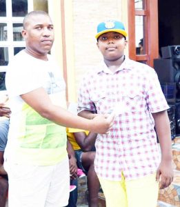 David Hunte (left) presents  Millik Fausette with his prizes.