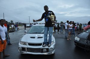 Former champion  Anand Ramchand  poses with his accolades from a  previous Meet.