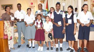 Jennifer Cipriani of Scotia Bank Poses with Rose Hall Town Council Officials and Students with copies of the Booklet.