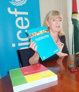 UNICEF’s outgoing representative, Ms Marianne Flach, displays a copy of the Situation Analysis document.