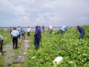 Ranks of the Springlands Police Station, neighbourhood police and the community undertake a massive cleanup programme at Skeldon.