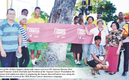 Golden Jaguars participate in Breast Cancer Awareness Tree Wrapping Exercise