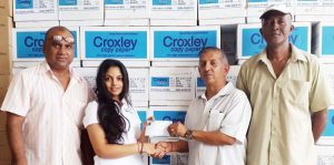 Nasheena Narine (second left) of WJ Enterprise presents the cheque to GFSCA President, Ramchand Ragbeer in the presence of Ricky Deonarain (left) and Wayne Jones.