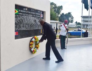 President Granger lays wreath at the Cubana Monument at, UG, Turkeyen Campus yesterday.