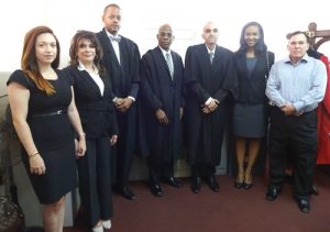 Flanked by family and friends from left to right: Dr Shannon Da Silva, Mrs Barbara Da Silva, Attorney–at-Law, Ronald Burchsmith, Justice Brassington Reynolds, Attorney-at-law Phillip Damien Da Silva, Naketa Da Silva, and Dr Phillip Da Silva. 