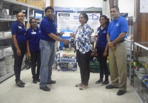 Ray Suknandan hands cheque to Deborah Ramotar-Skeete