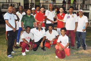 Man-of-the-match Ramo Malone (left) accepts his prize from Eric Plumer in the presence of his team mates.