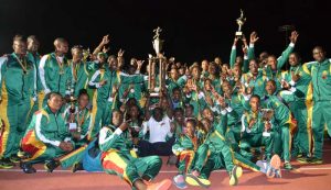 GDF Chief of Staff, Brigadier George Lewis (centre) hoists the Championships Trophy while his team celebrates last night at the NTFC at Leonora.