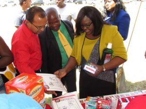 Minister Karen Cummings (at right) and other officials take time out to view some of the exhibits. 