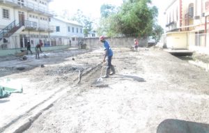 City Hall staff cleaning the empty lot just aback of Georgetown Magistrate’s Court 