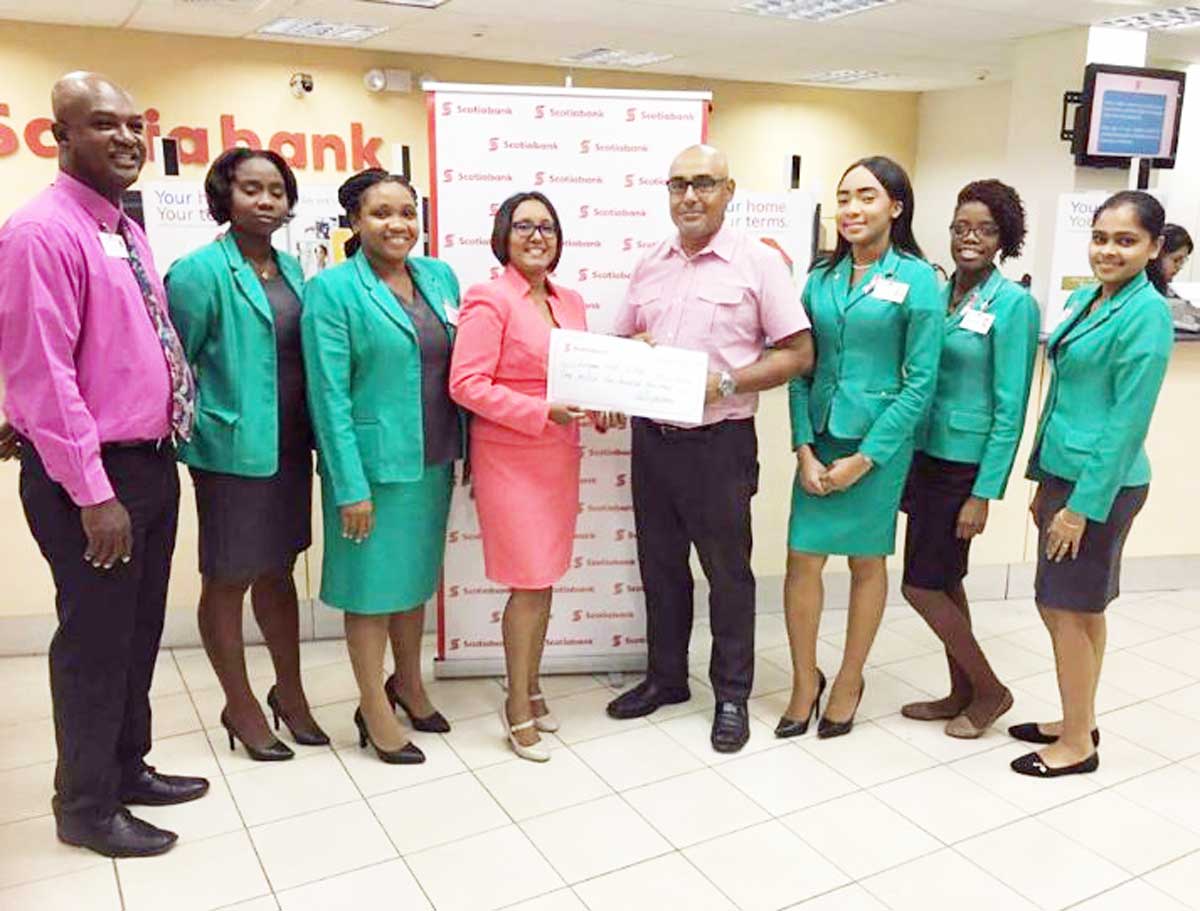 https://www.kaieteurnewsonline.com/images/2017/09/Products-and-Marketing-Manager-for-Scotiabank-Jennifer-Cipriani-hands-over-a-symbolic-cheque-to-Club-Captain-Brian-Glasford..jpg