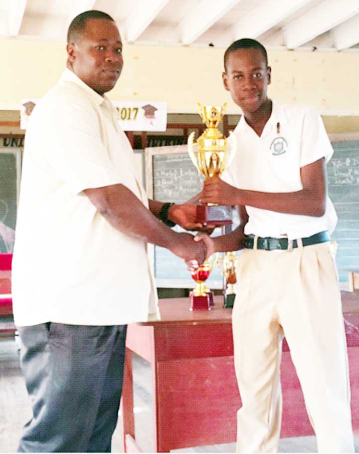 https://www.kaieteurnewsonline.com/images/2017/10/Individual-Category-First-Prize-winner-Darwin-London-Nurse-of-Berbice-Educational-Institute-receives-his-trophy-from-Head-teacher-of-host-school-Wellington-Park-Primary-Mr.-Bourne..jpg