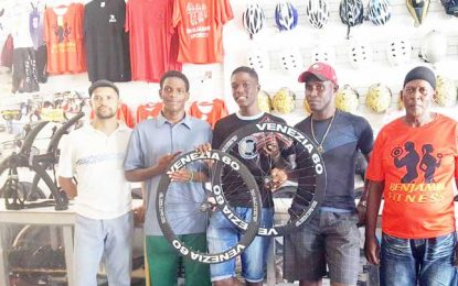 Wilbert Benjamin gives Carbon Fibre Wheels and tyres to Romello Crawford