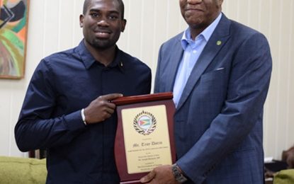 Ministry of the Presidency recognises Troy Doris for Commonwealth Games gold -presented with plaque and gold band