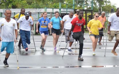 Persons with Disabilities brave rain for Day of Sports