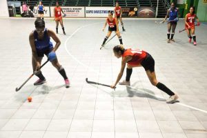 Players battle for possession in the contest between GBTI GCC Spice (blue) and YMCA Old Forte Bloods.  