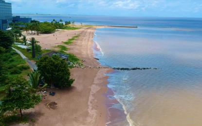 Body of woman on beach behind Marriott hotel