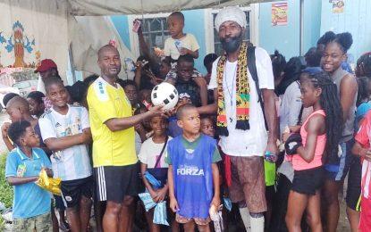 GFF President Wayne Forde donates football equipment to youths in Albouystown on New Year’s Day